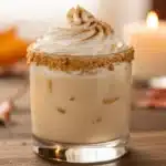 Pumpkin Spice White Russian cocktail with whipped cream and spice rim